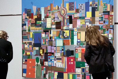 Visitors take a close look at Mission School artist Chris Johanson's 2003 piece, Cityscape with House and Energy. 