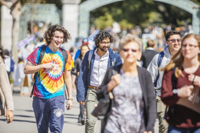 students walking on campus, smiling