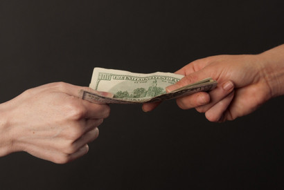 hands passing money