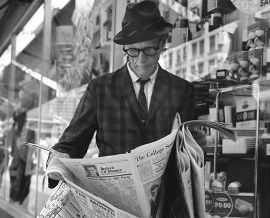 Man reading newspaper.