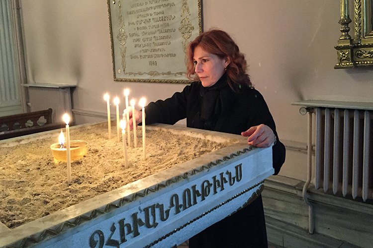 lighting a candle in Armenian church