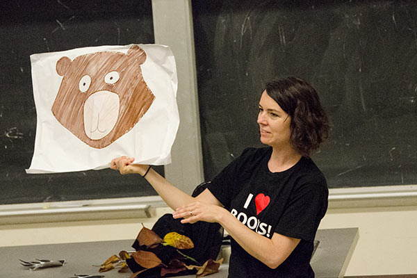 woman holding bear cue card