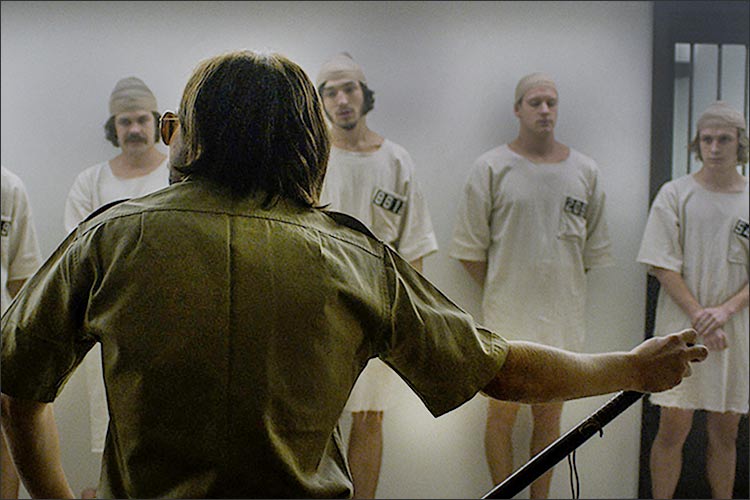 movie still: prisoners and guard