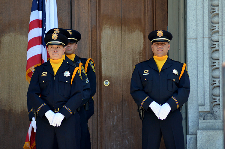 UC Berkeley police stand with flag