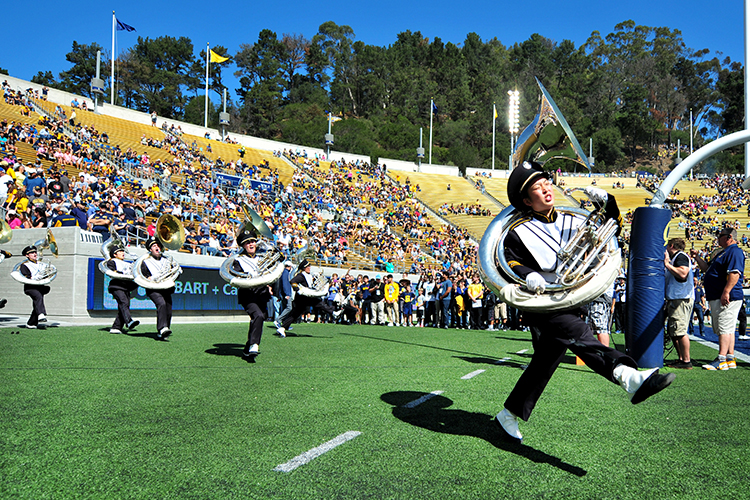 The Cal Band demonstrates the strut, one of its signature steps, on the field at Memorial Stadium.