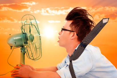 man with fan on hot day