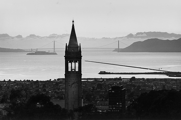a black and white image of sather tower and the golden gate bridge