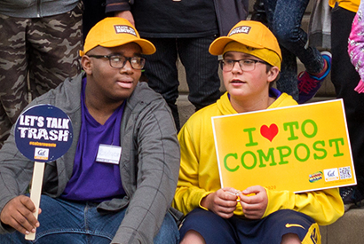 youth with composting signs