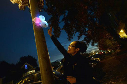 A student tests an urban sensor installed to both engage passers-by with interactive light art and to collect data about pedestrian activity in San Leandro. Courses in the interdisciplinary initiative allow students to design and build urban field experiments as well as to observe and study cities. (Unknown photographer.) 