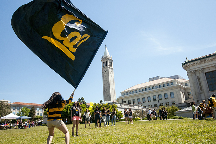 student waving Cal flag