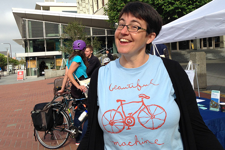 woman in T shirt with bicycle image