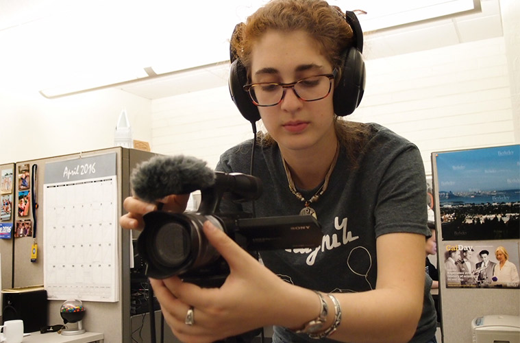 student with video camera