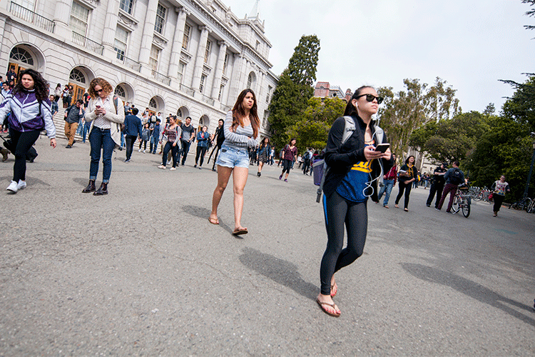 students walk on front of wheeler hall