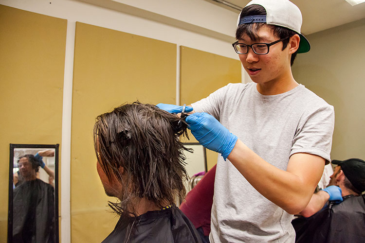 student giving a haircut