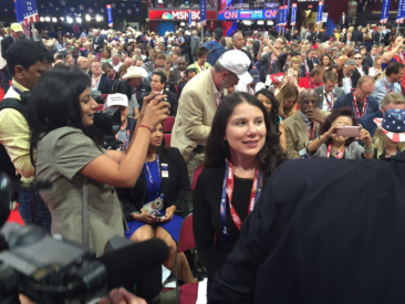 Claire Chiara stands a the crowd of delegates at the Republican National Convention