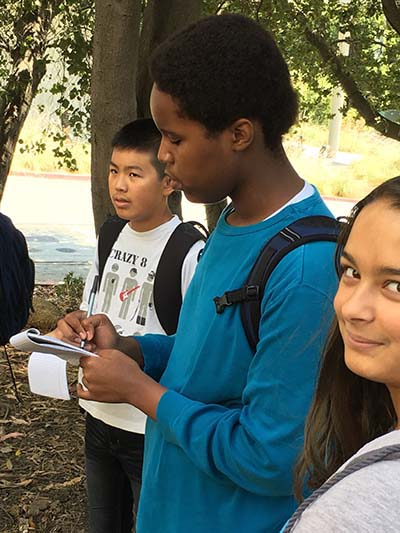 Teens Joshua Chang, Jude Muriithi and Sonja Kaleva conduct interviews for an ADTP assignment. (UC Berkeley photo by Gretchen Kell)