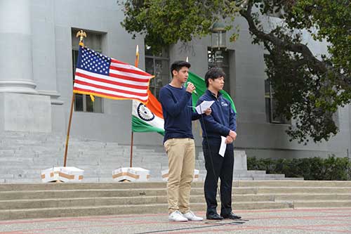 Jong-Ha Lee and Jay Sananvatananont speak with the U.S., India, and Bangladesh flags behind them.