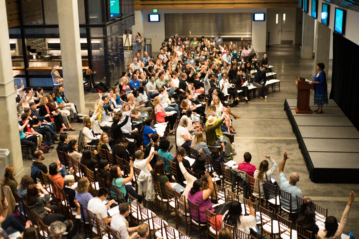 Overhead shot of many people in an auditorium during the conference