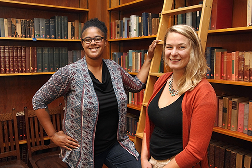 Graduate student residents Rachel Roberson (left) and Sydney Aardal get familiar with Bowles' Hart Library.
