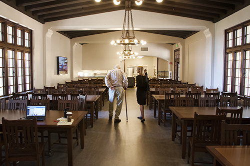 Sayles and Melissa Bayne, the hall's new dean, walk through the updated dining hall, with its rebuilt iron light fixtures and flat screen TV.