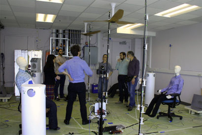 Researchers with UC Berkeley’s CBE discuss a laboratory test configuration. (Photo by CBE.)