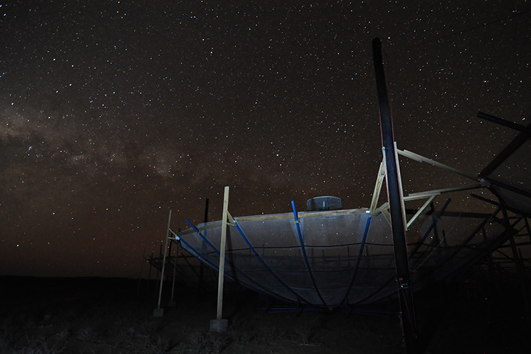 one of the dishes of the HERA array seen at night