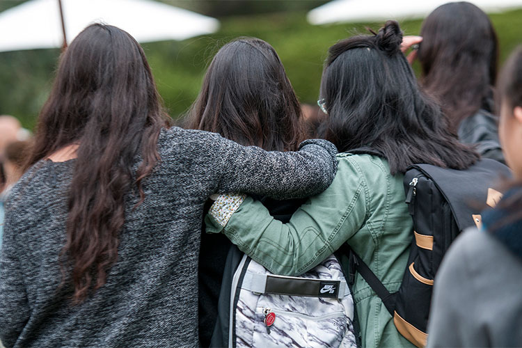 students with arms around each other