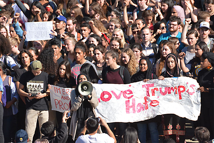 A crowd of undocumented students at Berkeley holds a noon protest against Trump's policies.