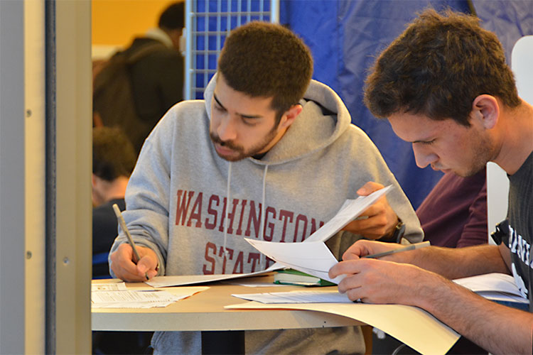 two students filling out ballots