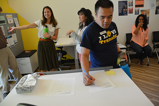 Steven Nguyen signs in at an open house event.