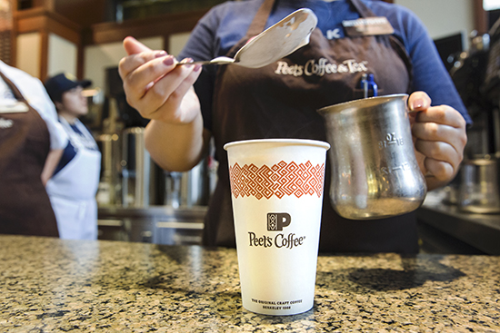 A barista preparing a drink at Peet's Coffee.