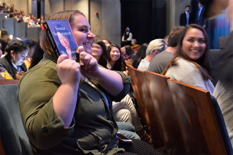 audience member with book