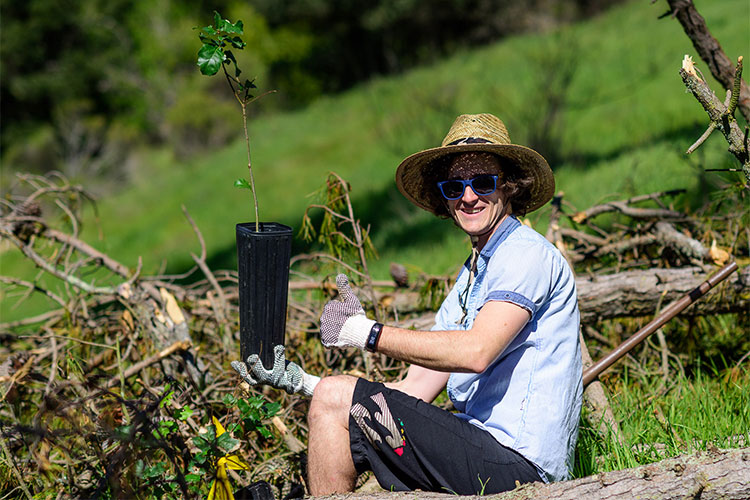 student with baby tree