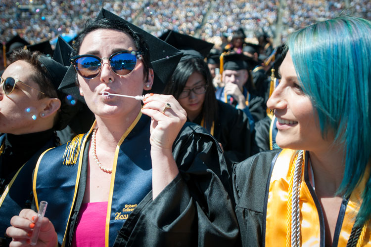 graduates blowing bubbles