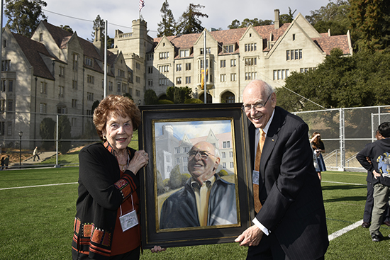 Sayles and his wife, Judy, holding his portrait during the Bowles Hall reopening event.