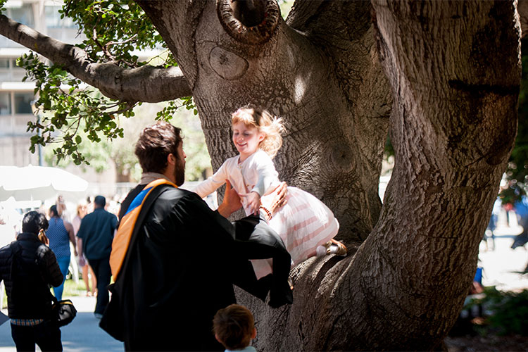 child leaping from tree