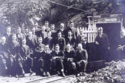 Dean Andrew Lawson (far right) and 1917 School of Mining students sitting in front of the mouth of Lawson Adit.