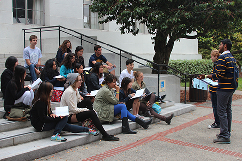 Students sitting on outdoor steps during an orientation session at UC Berkeley.