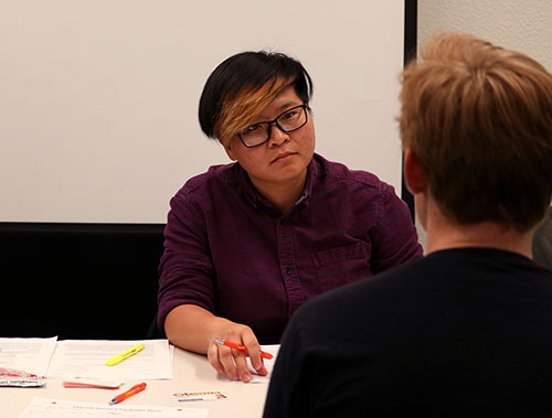 A CalFresh clinic staff member listens to a student during a one-on-one session at Stiles Hall.