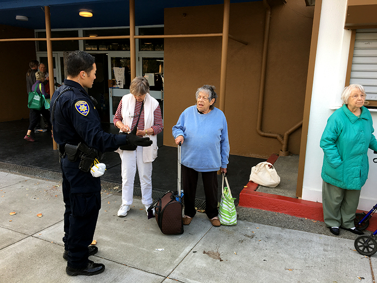 A UCPD officer speaks with Santa Rosa residents on Tuesday. Nine campus police officers have responded to the disaster. (UCPD photo)