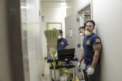 Cris Gomez, a UC Berkeley graduate and campus counselor, listens to instructions on how to clean the bathroom while volunteering at a shelter in Santa Rosa on Friday. (UC Berkeley photo by Jeremy Snowden)