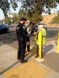 A UCPD officer speaks with Santa Rosa residents on Tuesday. Nine campus police officers have responded to the disaster. (UCPD photo)