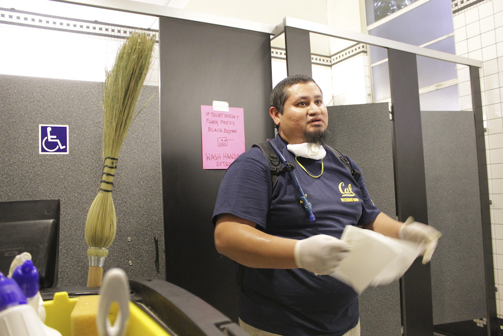 Luis Hernandez, a UC Berkeley graduate and counselor at the Cal Veteran Services Center, cleans a bathroom at an evacuation center in Santa Rosa on Friday. (UC Berkeley photo by Jeremy Snowden)