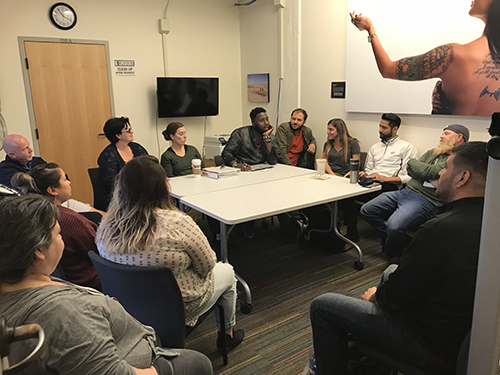 A meeting of the OWLs group in Hearst Gym's Room 100, with participants seated around a table.