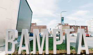 Statue spelling out the word BAMPFA