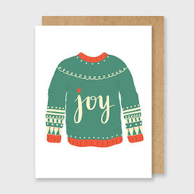 White greeting card featuring a green sweater with red trim that states "joy."