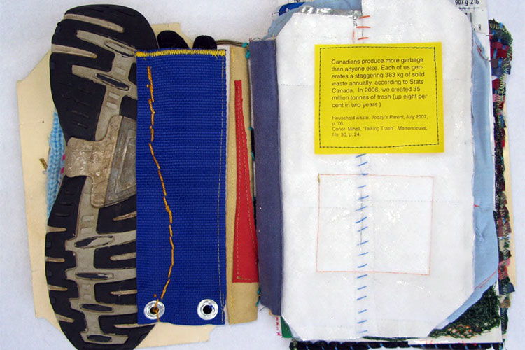 An open artist's book titled More Garbage by Lisa Melhorn-Boe, made from found objects, including part of a shoe sole and fabric. 