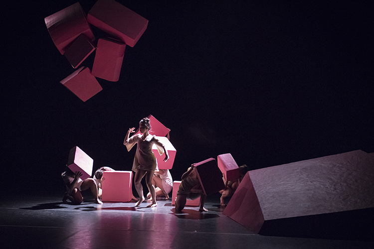 Dancers perform 'Bone Worrier' by Katie Faulkner, interacting with large pink blocks on stage.