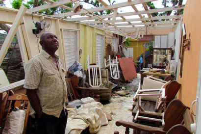 man in broken down house in Puerto Rico