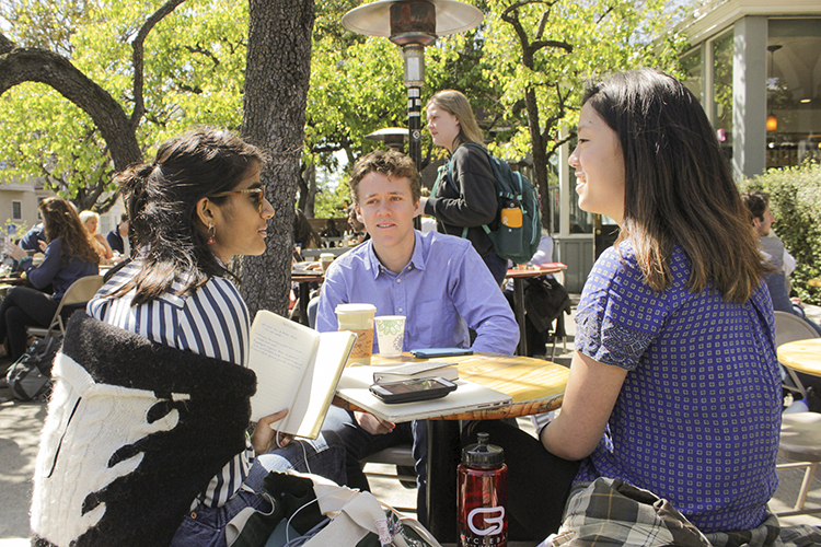 Anjali Banerjee, Tyler Heintz, and Alice Ma from the Archer team collaborate outdoors at Caffe Strada.